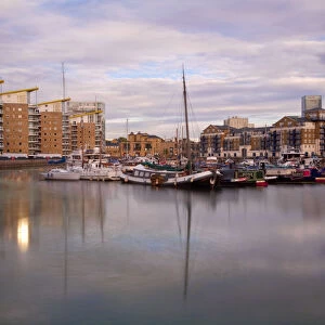 England, London, Tower Hamlets, Limehouse Basin with Canary Wharf buildings in background