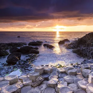 An epic sunset at the Giants Causeway with its iconic basalt columns