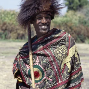 An Ethiopian man wears a headdress made from the skin of a gelada