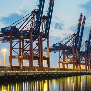 Empty Eurokai loading quay with cargo container cranes at night, Waltershofer Hafen