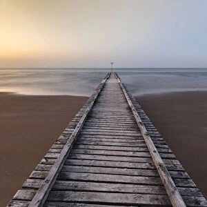 Europe, Italy, Veneto, Venice, Jesolo. A wooden pier on the beach towards adriatic sea
