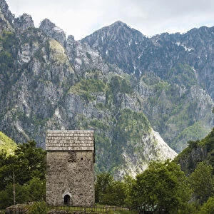 Exterior of building with The Accursed Mountains in background, Theth, Albania