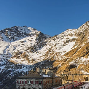 The famous Bernina Express red train at Alp Grum station, Graubunden, Switzerland