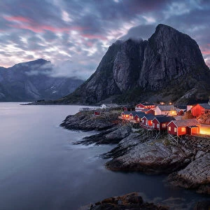 The famous red cabins of Hamnoy catching the last light of the day on a explosive summer sunset. Lofoten Islands, Norway