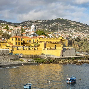 Fishing boats and Sao Tiago fortress. Funchal, Madeira Island, Portugal