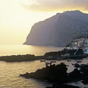 The fishing harbour of Camara de Lobos and Girao Cape at sunset, Madeira, Portugal