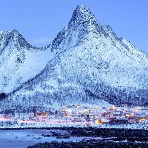 Fishing village of Mefjordvaer and snowy mountains at dusk, Senja, Troms county, Norway Fishing village of Mefjordvaer and snowy mountains at dusk, Senja, Troms county, Norway