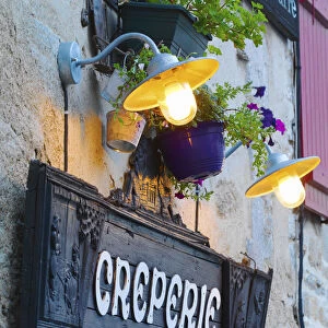 France, Brittany, Finistere, Quimper, Old town, Creperie sign at dusk