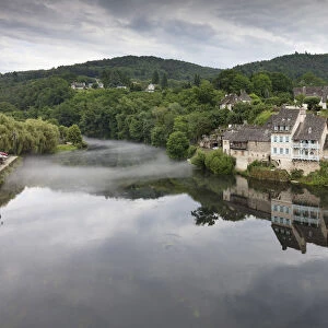 France, Correze, Argentat, The old town reflected in the Dordogne river with some