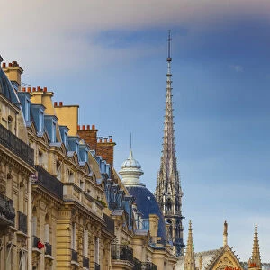 France, Paris, Notre Dame Cathedral, spire above rooftops