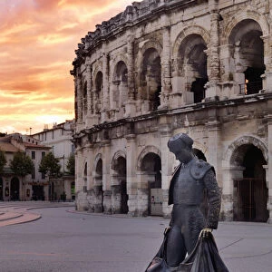 France, Provence, Nimes, Roman ampitheatre, Toreador statue at sunset