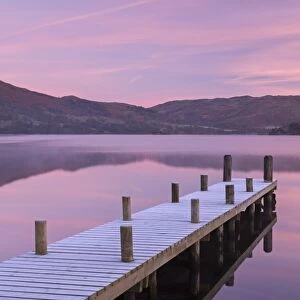 Frosty wooden jetty on Ullswater at dawn, Lake District, Cumbria, England. Winter