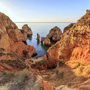 Golden sunrise on the red cliffs of Ponta da Piedade Lagos Algarve Portugal Europe