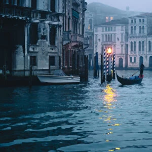 Gondolas near Rialto bridge during a cloudy day. Venice, Veneto, Italy