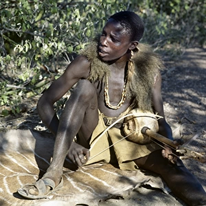 Hadza youth sings to the accompaniment of his two-stringed musical instrument