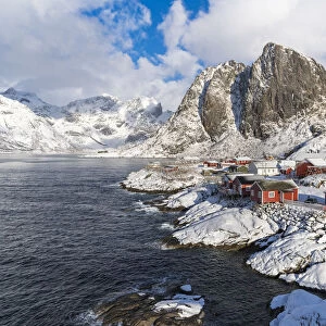 Hamnoy village covered in snow, with Festheltinden peak in the background