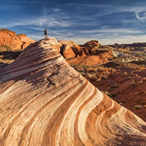 Hiker on Fire Wave, Valley of Fire State Park, Nevada, USA