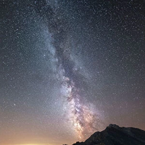Hiker under the Milky Way at Agnello Pass, Valle Varaita, Piedmont, Italy