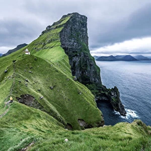 Hiker near the Kalsoy Lighthouse, Faroe Islands, Europe