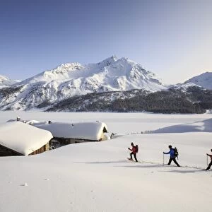 Hikers on snowshoes, Spluga, Maloja Pass. Engadine. Switzerland. Europe