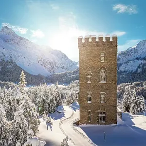 Historic Belvedere tower covered with snow, Maloja, Bregaglia, Graubunden canton, Engadin, Switzerland Historic Belvedere tower covered with snow, Maloja, Bregaglia, Graubunden canton, Engadin, Switzerland