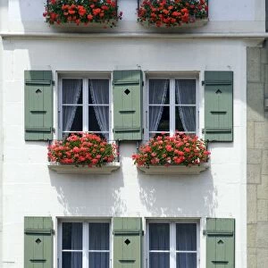 Front of a house with flowerboxes in Bern, Switzerland