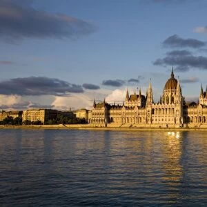 Hungary, Budapest. The Parliament Building by the River Danube, catches the last of the evening sun