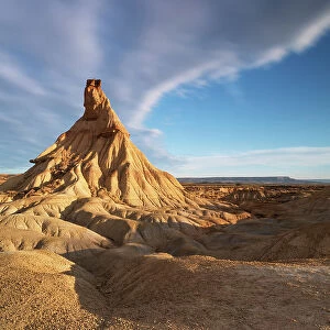 the iconic rock formation called Castel de Tierra during a warm summer sunrise, Bardenas Reales Natural Park, Navarra, Spain