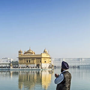 India, Punjab, Amritsar, a sikh pilgrim praying at the Golden Temple - the holiest