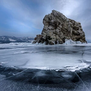 An island surrounded with flat ice over lake Baikal, Irkutsk region, Siberia, Russia