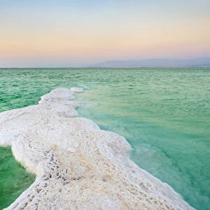 Israel, South District, Ein Bokek. Salt formations on the Dead Sea at sunset