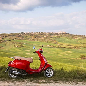Italian vespa motorcycle in the countryside. Val d Orcia, Tuscany, Italy (PR)