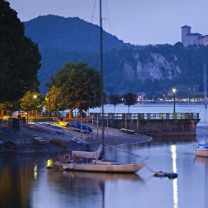 Italy, Piedmont, Lake Maggiore, Arona, lakefront view with La Rocca fortress in Angera