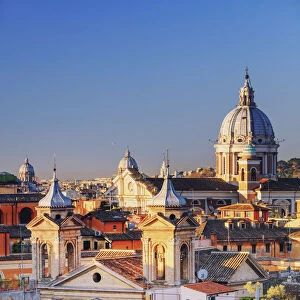Italy, Rome, Basilica Sant Ambrogio e Carlo church and city roofs at sunrise