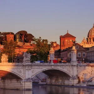 Italy, Rome, St. Peter Basilica at sunrise reflecting on Tevere river