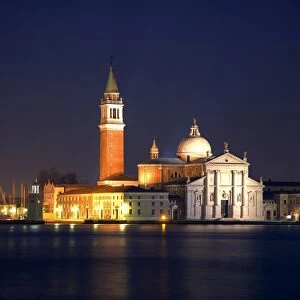Italy, Veneto, Venice; The Church prominently lit during the night, across the Bacino di San Marco