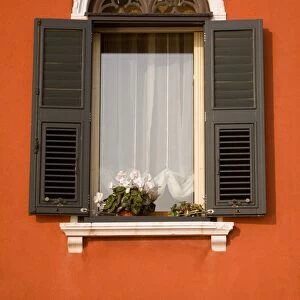 Italy, Veneto, Venice; A typical Ventian window with persiane - shutters which keep out too much light while leaving the possibility to