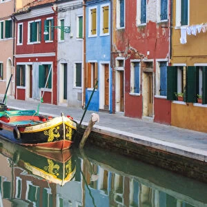 Italy, Venice, Burano. View of a canal with typical colorful houses