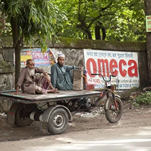 Jessore, Bangladesh. Two men take a rest from transporting goods around Jessore