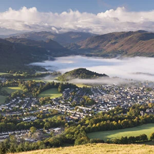 Keswick and mist covered Derwent Water at dawn, Lake District, Cumbria, England. Autumn