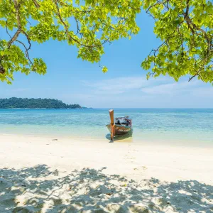 Ko Lipe, Satun Province, Thailand. Traditional long tail boat moored on an empty beach