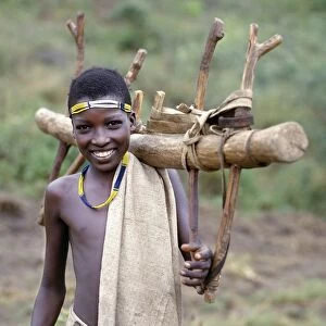 A Konso youth of southwest Ethiopia carries home a