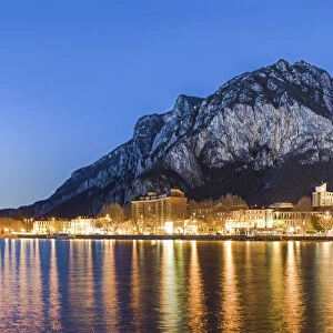 Lake Como, Lombardy, Italy. Lecco city at dusk with St Martin mount in the background
