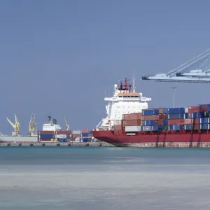 A large container vessel discharges its cargo at the port of Djibouti