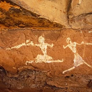 Libya, Fezzan, Jebel Akakus. A pair of running figures painted onto the walls of Uan Muhuggiag