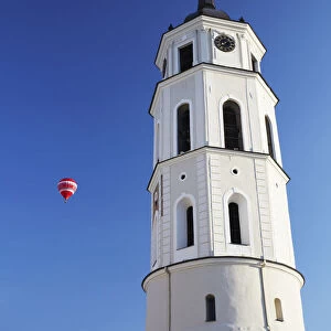 Lithuania, Vilnius, Hot Air Balloon Flying Past Vilnius Cathedral Belfry