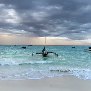 Local fishermen on a traditional dhow, in stormy weather, Nungwi, Zanzibar, Tanzania Local fishermen on a traditional dhow, in stormy weather, Nungwi, Zanzibar, Tanzania