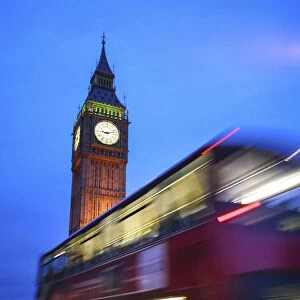 London, UK, Double Decker red bus passing in front of the Big Ben illuminated at dusk