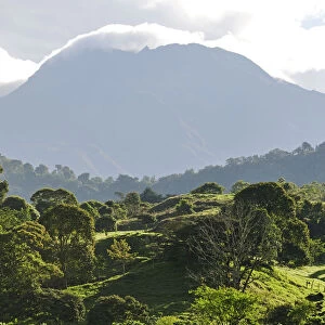 Looming shadow of Volcan Baru overlooking Rain Forest below, Panama, Central America