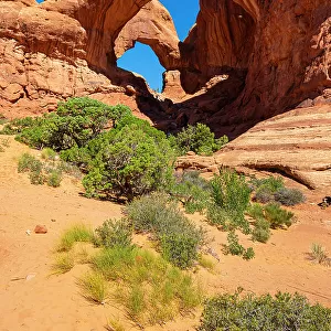 Low angle view of popular Double Arch on sunny day, Arches National Park, Utah, USA